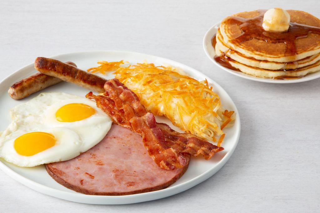 Ultimate Breakfast · 2 cherrywood-smoked bacon strips, 2 sausage links and grilled ham steak. Served with 2 eggs any style, 3 made‑from‑scratch buttermilk pancakes and hash browns. Egg whites or low-cholesterol egg substitute available.