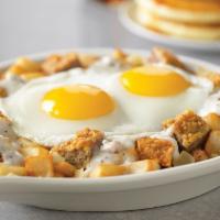 Chicken-Fried Steak Skillet · Savory chicken-fried steak and onions topped with country sausage gravy over country potatoes.
