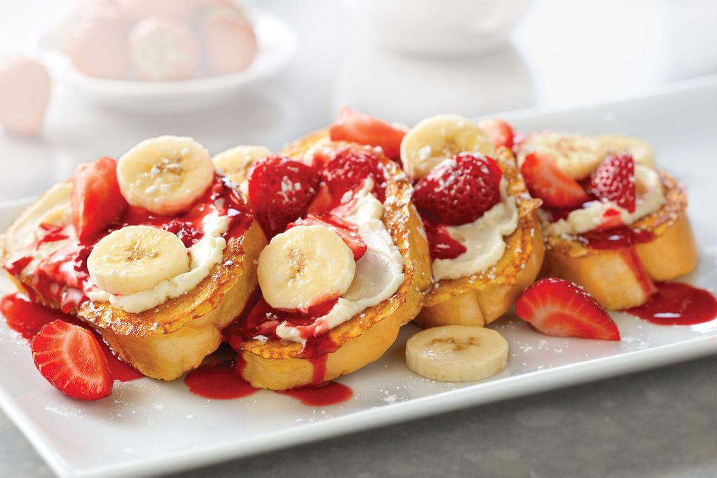 Strawberry-Banana Supreme French Toast · Four slices of vanilla-battered French toast topped with sweet supreme cream, fresh strawberries, and sliced bananas.