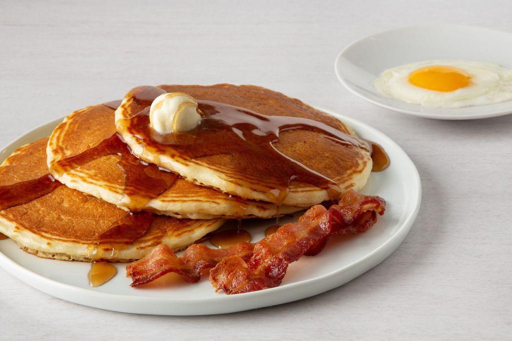 Buttermilk Pancake Combo · 1 egg, any style, 3 buttermilk pancakes with 2 cherrywood-smoked bacon strips or two sausage links.