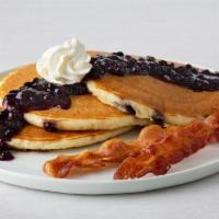 Double Blueberry Pancakes · Three buttermilk pancakes with blueberries, topped with blueberry sauce and whipped cream.  ...