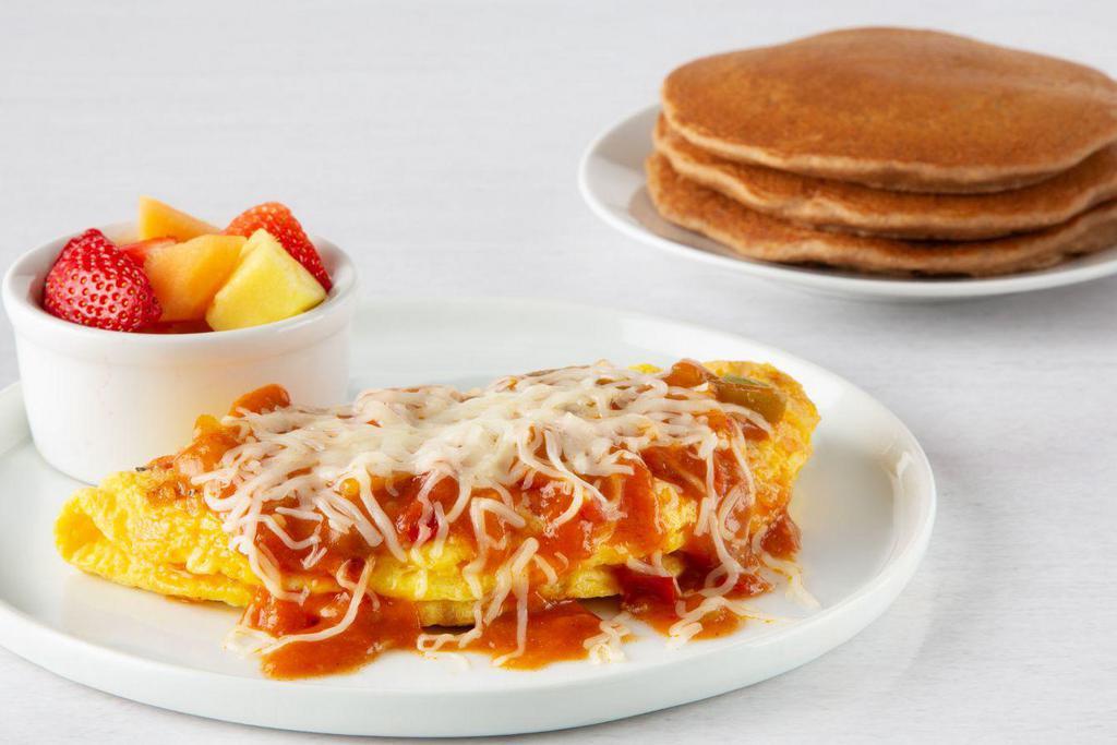 Garden Veggie Omelette · Low-cholesterol egg substitute, onions, green peppers, tomatoes, and mushrooms. Topped with ranchero sauce and mozzarella cheese. Served with only fresh fruit and multigrain pancakes.