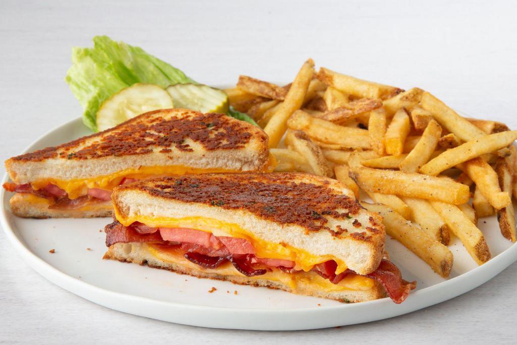 Grown-Up Grilled Cheese · American, cheddar, Monterey Jack, and mozzarella cheeses, cherrywood-smoked bacon and grilled tomato slices on grilled Parmesan-crusted bread.