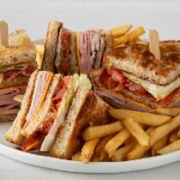 Double Decker Club · Hand-carved turkey breast, ham, cherrywood-smoked bacon and American cheese with tomato, let...