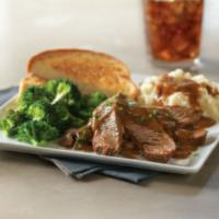 Pot Roast · Sliced tender pot roast topped with brown gravy and served with Texas toast. Served with cho...