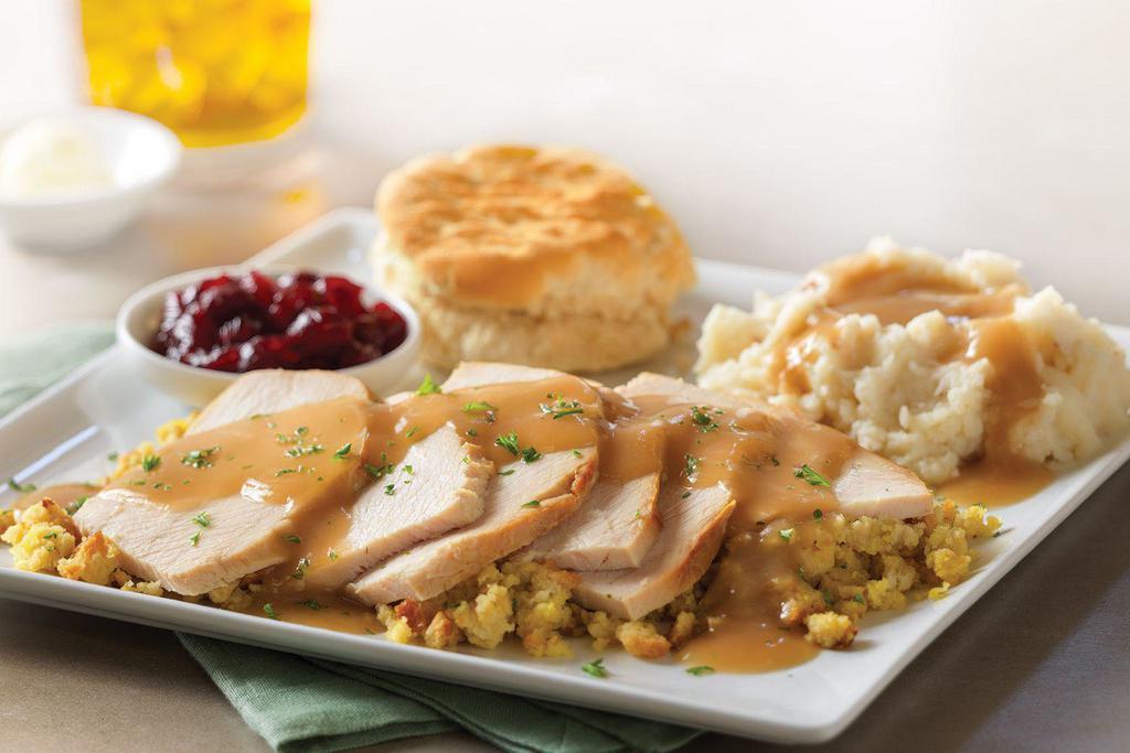 Slow Roasted Turkey · Hand-carved and served with cornbread stuffing, mashed potatoes and turkey gravy, cranberry sauce and a buttermilk biscuit.