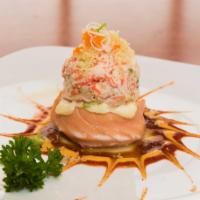 Volcano Scallop · Baked scallop wrapped with salmon topped with snow crab.