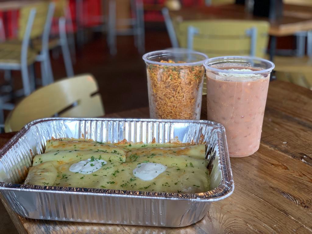 Chicken Enchiladas Suizas Meal for 4 · Machaca chicken, red Chile sauce, tomatillo sauce, jack geese, and topped with sour cream. Your choice of coconut rice or Navajo rice and either black beans or bolo beans.
(Price reflects 40% discount)