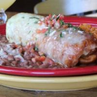Chimichanga · Flour tortilla, choice of meat, Navajo rice, smothered in tomatillo cream sauce, red chile s...