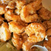 Firecracker Shrimp · A 1/2 lb. of breaded, crispy fried shrimp tossed in our spicy cream sauce. Sauce is served o...