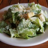 Classic Caesar Salad · Romaine tossed in our Caesar dressing, topped with Parmesan cheese and croutons.