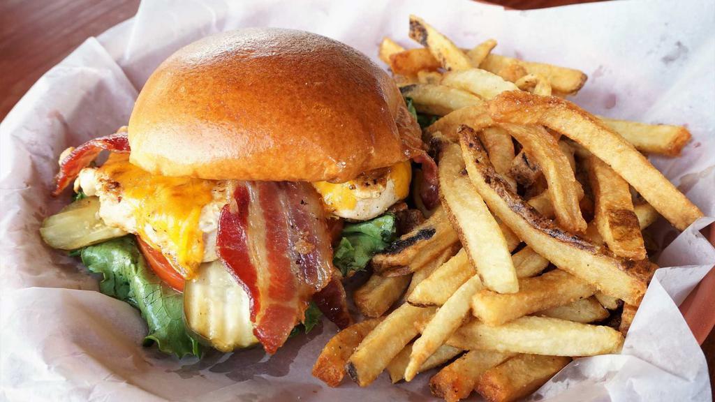 Cheddar Chicken Sandwich · A fresh chicken breast marinated, grilled and topped with mayonnaise, lettuce, tomato, cheddar cheese, and bacon on a brioche bun. Add pickle for an additional charge.