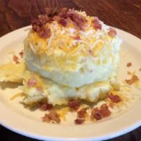 Loaded Mashed Potatoes · Whipped, buttery mashed potatoes topped with cheese and bacon.