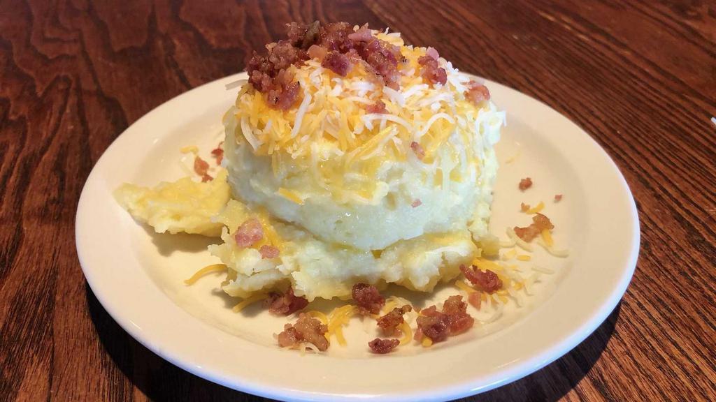 Loaded Mashed Potatoes · Whipped, buttery mashed potatoes topped with cheese and bacon.