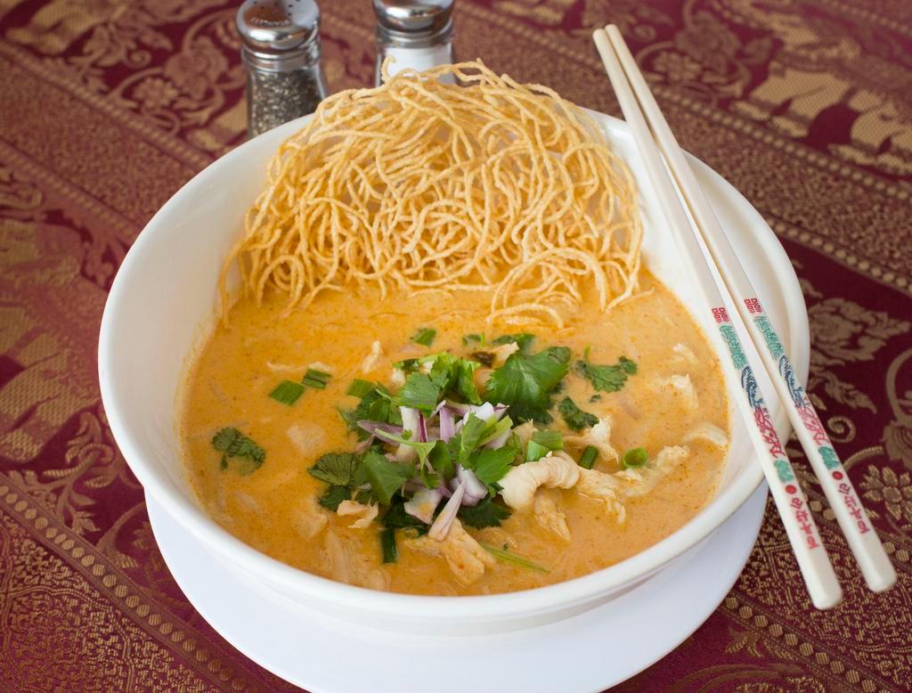 Ns2. Khao Soy · Egg noodles in curry. Choice of chicken, pork or tofu with egg noodles in curry. With egg noodles onions, cilantro and bean sprouts in the northern style mixed yellow and red curry topped with crispy egg noodles.