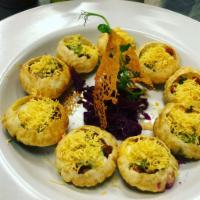 Dahi Batata Sev Poori · Small pooris filled with lentils and potatoes, topped with yogurt and herbs. Contains gluten. 