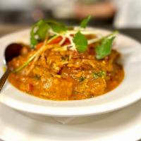 Goat Curry · Baby goat, slow cooked on the bone with onions, tomatoes and spices. 
