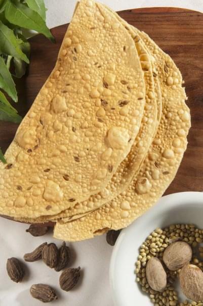 Pappad · A Papadam or Appalam is an Indian cracker ,cooked with dry heat until crunchy.  Made from lentils, chickpeas, rice