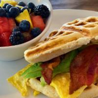 Waffle Sandwich · Fresh Belgian waffle stuffed with scrambled eggs, bacon and avocado. Served with choice of p...