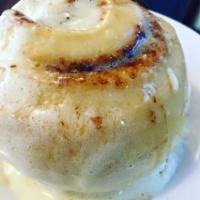 Cinnamonster · Cinnamon roll served warm, dripping in cream cheese frosting.