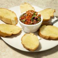 Bruschetta · Sliced fire baked Italian bread topped with olive oil, fresh chopped red onion, tomato and b...