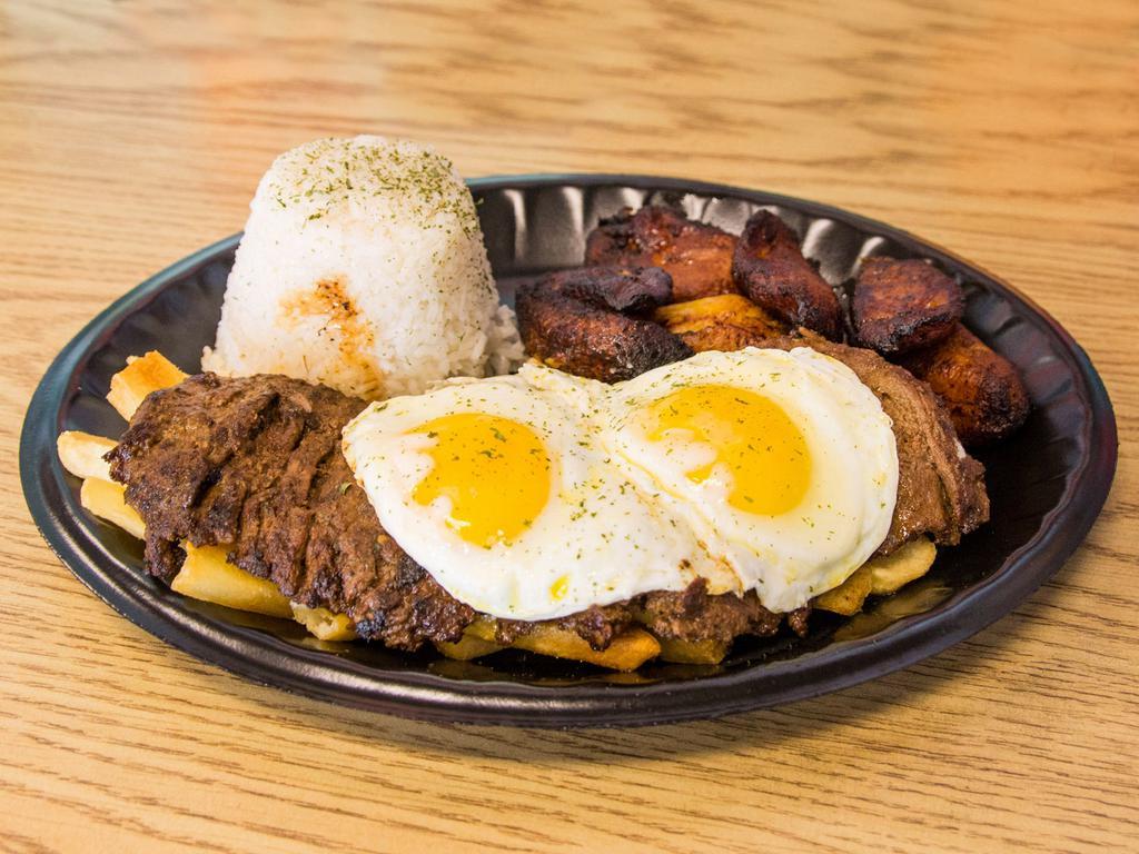 Bistek a lo Pobre · Marinated steak topped with an over easy egg served with fries, plantain and rice.