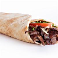 Beef Shawarma · Beef, tomatoes, turnip pickles, cucumber pickles with tahini sauce and parsley, onions and s...