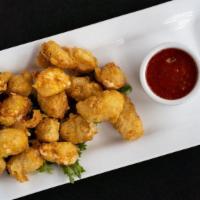 -Fried Cheese Curds · Beer-battered cheese curds fried and served with a spicy pepper jam.