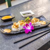 Baked Scallop Roll · California roll topped with baked scallop and dynamite sauce with eel sauce.