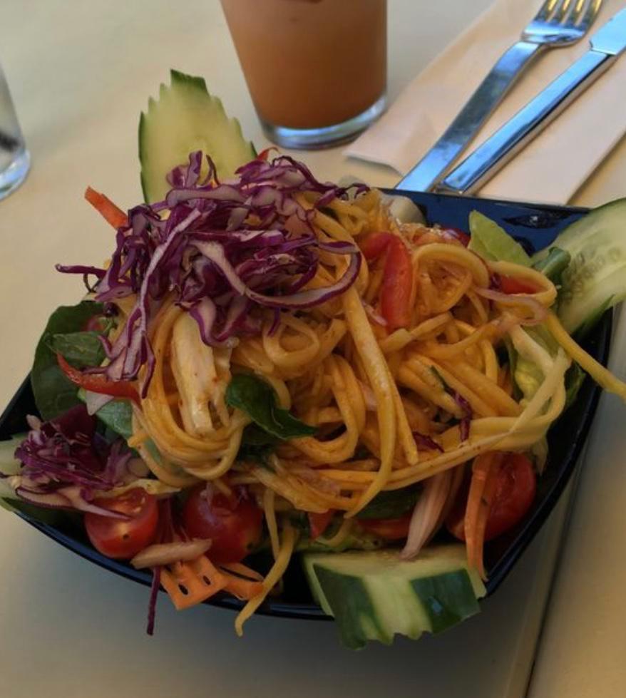 Spicy Mango Salad · Shallots, tomatoes, bell peppers, red cabbage and mint in a spicy chili lime juice.