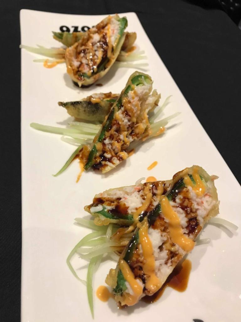 Stuffed Jalapenos · Tempura-fried jalapenos stuffed with cream cheese, mayo, snow crab mix. Topped with eel sauce and spicy mayo