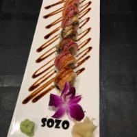 Tiger Roll · Spicy salmon & avocado rolled in seaweed & rice. Topped with tuna, salmon, & eel. Finished w...
