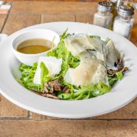 Insalata Rucola and Parmigiano · Arugula, mushrooms, shaved Parmigiano cheese and lemon vinaigrette. Dressing served on the s...