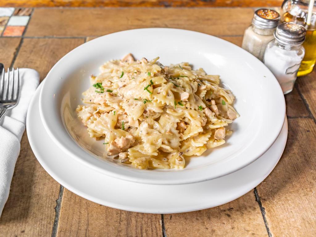 Farfalle al Salmone · Salmon marinated in vodka w bowtie pasta and roasted pecans in a creamy white sauce.