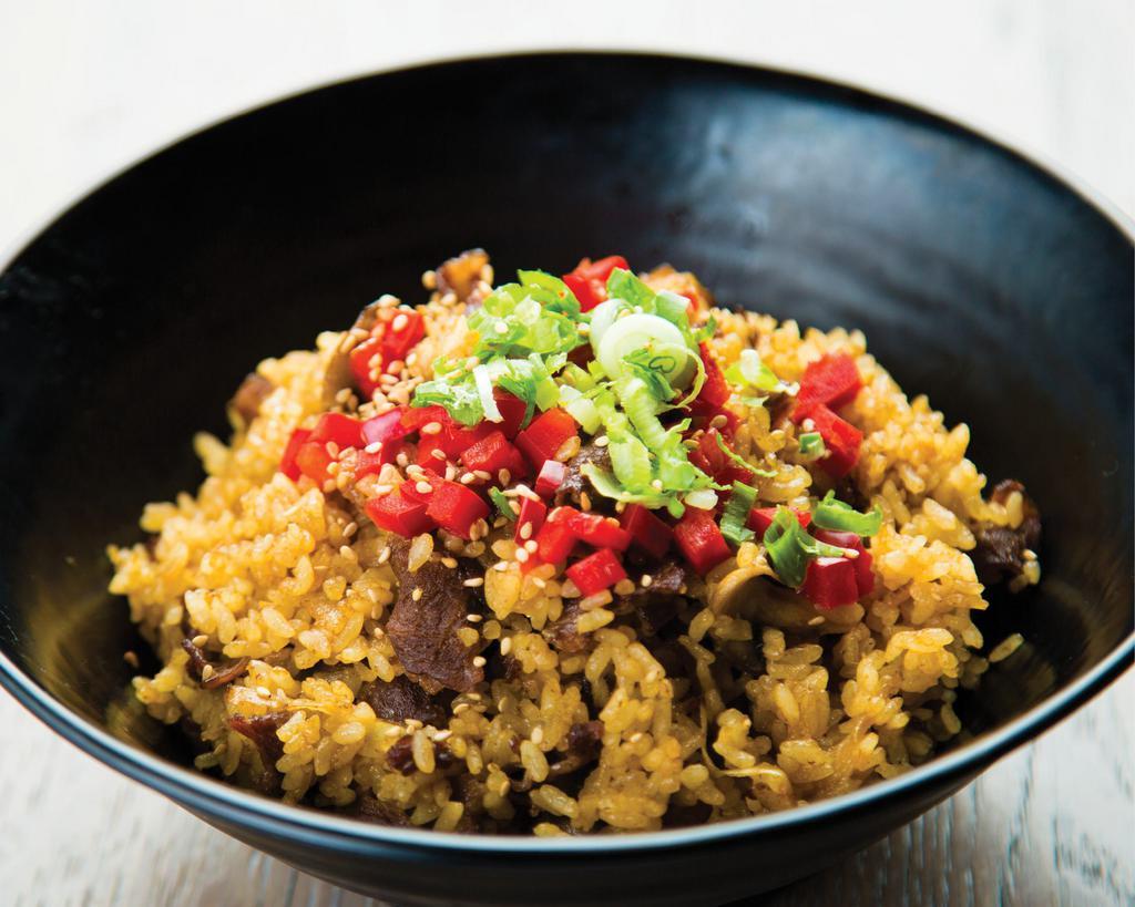 Sukiyaki Fried Rice with Beef Bowl · Our signature thin-sliced Sukiyaki-marinated beef stir-fried with white rice, egg yolk, mushrooms, and sliced onions. Topped with diced red bell peppers, chopped green onions, and sesame seeds.