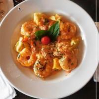 Shrimp Scampi · Fresh jumbo shrimp, lemon garlic scampi and over pasta.