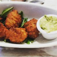 Codfish Fritters · Hush puppies made with salted codfish and served with avocado cream.