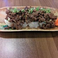 Bulgogi Roll · CA roll topped with Korean BBQ bulgogi, sesame seeds, green onions and eel sauce.