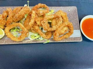 Crispy Calamari · Battered and flash fried served with lime wedge and sweet chili sauce.
