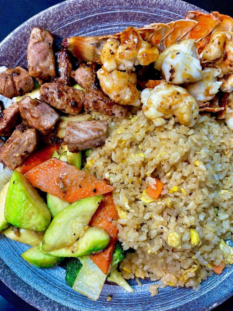 Hibachi Filet Mignon and Lobster Tail · Hibachi Style Filet Mignon and Lobster Tail with wok sauteed vegetables and fried rice.  Served with mushroom soup and house salad.  Yum Yum sauce and Ginger Sauce on the side. 