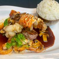 Surf and Turf · Grilled filet mignon, lobster tail, and shrimp, served with mushroom truffle sauce.  Served ...