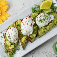 Avocado Toast · Fresh avocado spread on multi-grain toast with 3 poached organic eggs, sea salt and red pepp...