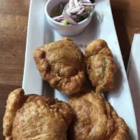 Thai Samosa · Deep fried Thai-style vegetable curry puffs served with cucumber salad.