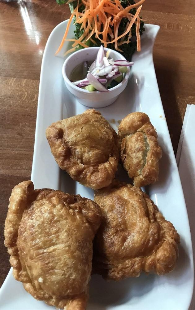Thai Samosa · Deep fried Thai-style vegetable curry puffs served with cucumber salad.
