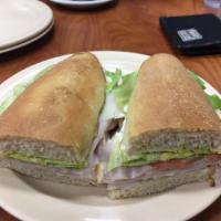 Turkey Sub · Thinly sliced oven roasted turkey breast perfectly layered & topped with provolone & Swiss c...
