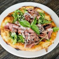 Parma Bianca Pizza · Prosciutto di Parma, vinaigrette, mozzarella, Reggiano and baby arugula.
