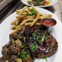 Double R Ranch New York Strip Steak  · grilled 10 oz. prime strip, natural jus, aged balsamic, wild mushrooms,  and hand cut fries. 