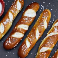 Soft Pretzel Sticks · Warm house-baked pretzels sprinkled with kosher salt & served with white cheddar queso dippi...