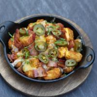 Loaded Tots · Golden tater tots loaded with queso, melted jack & cheddar, crisp bacon bits & fresh jalapeñ...