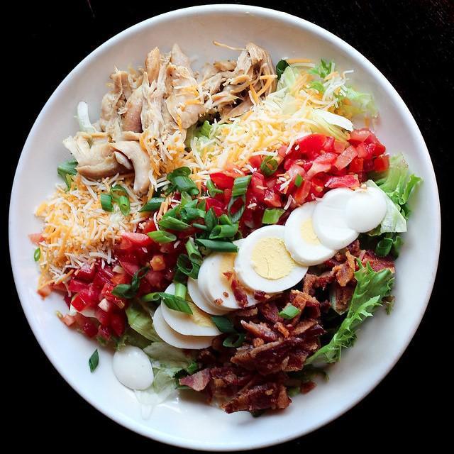 Doolittles Cobb Salad · Rotisserie chicken, cheddar and jack, bacon, egg, green onion, iceberg, mixed greens, tomatoes, and choice of dressing served on the side. GF